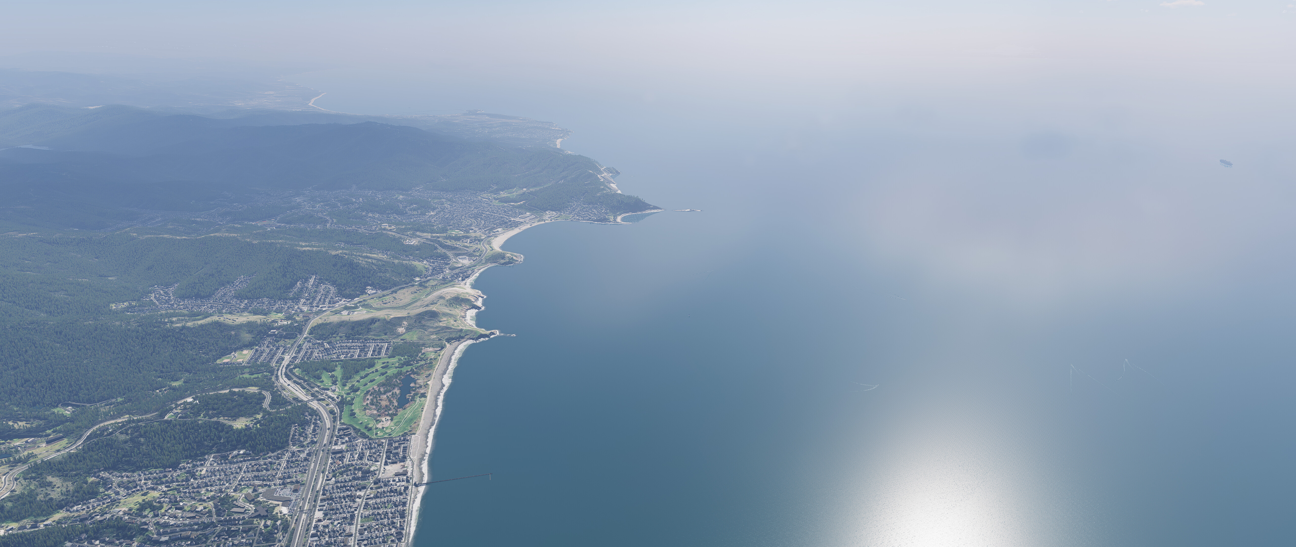 Screenshot from X-Plane showing a clear daytime view of Pacifica, CA coastline and Pacific Ocean from 2000ft above sea level, looking south towards Half Moon Bay